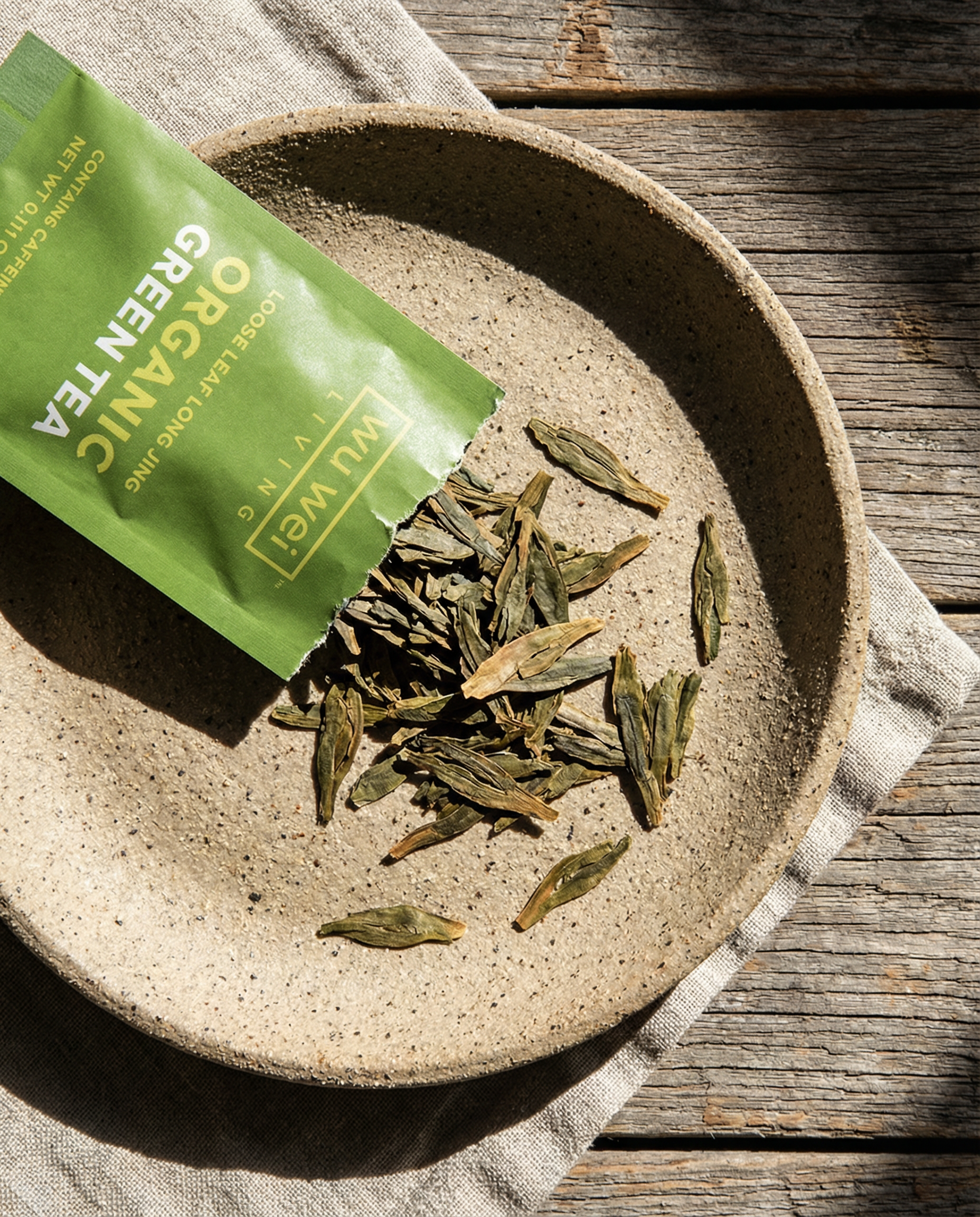 Organic Long Jing green loose leaf tea in a ceramic bowl — Wu Wei Living
