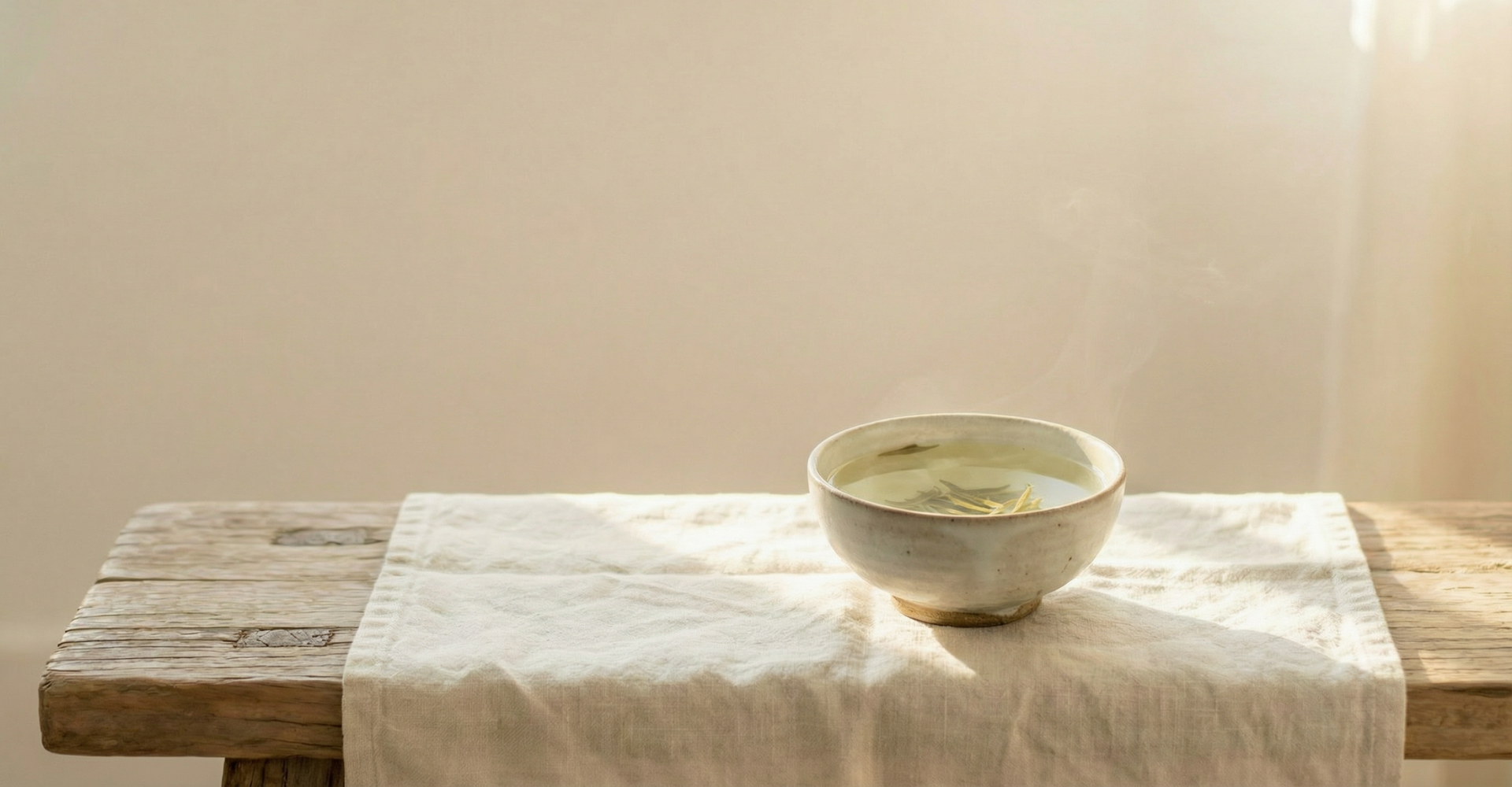 Ceramic bowl on a wooden table with a white cloth, soft lighting-Wu Wei Living